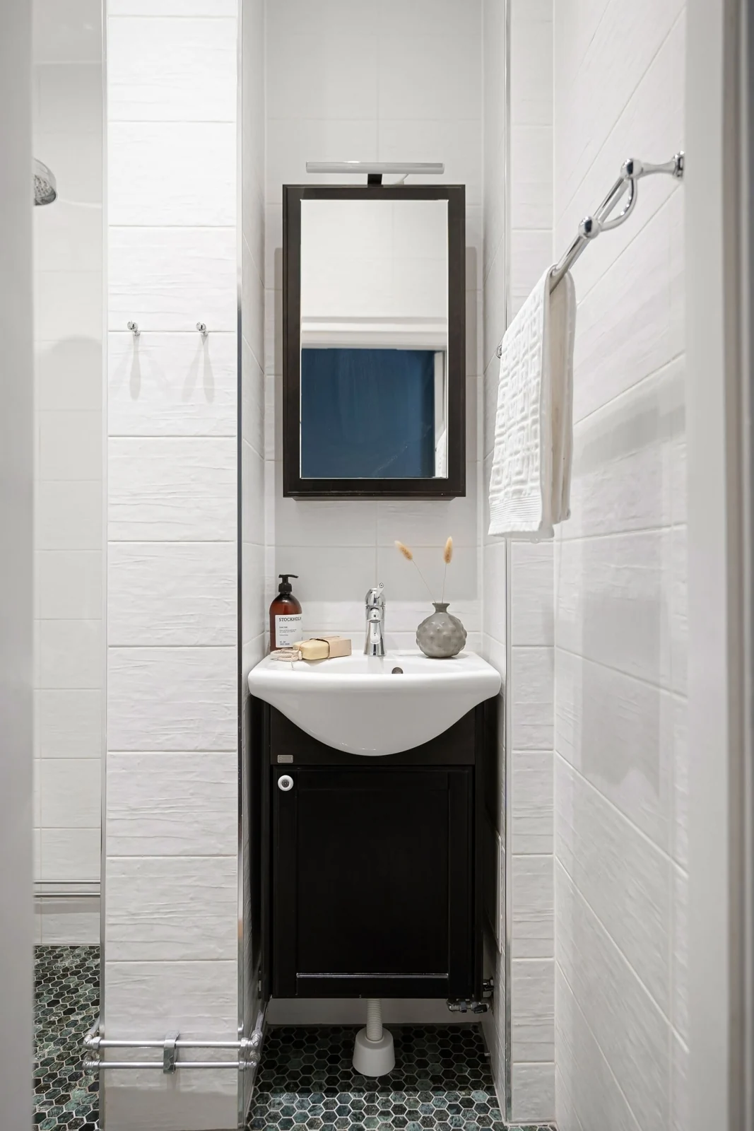 Narrow cloakroom with a small basin