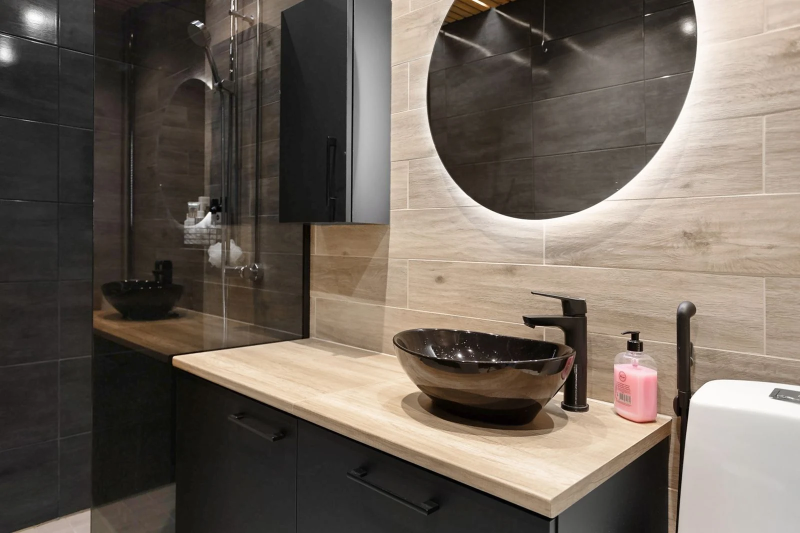 Elegant modern bathroom with stylish wooden vanity and backlit mirror, perfect for contemporary homes
