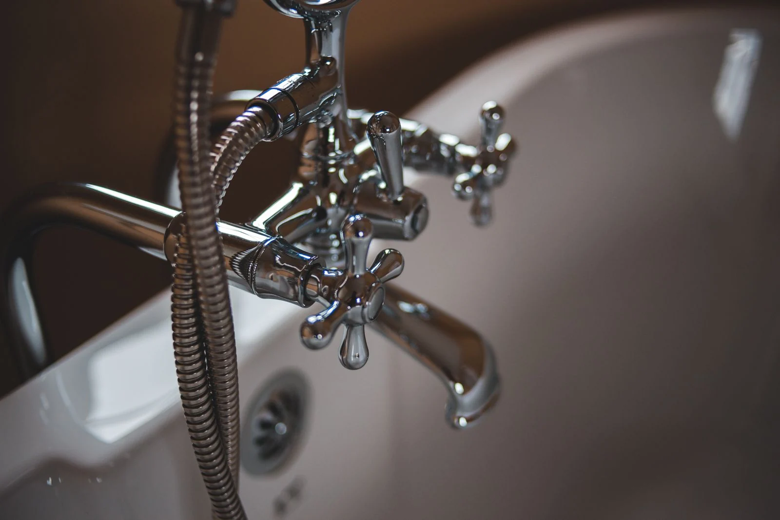 Elegant close-up of a shiny chrome faucet in a modern bathroom setting