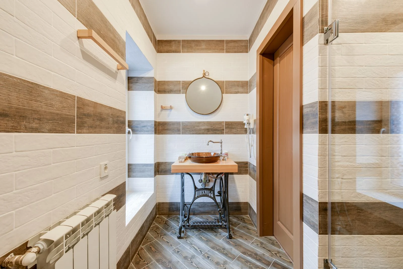Stylish bathroom with upcycled sink table and round mirror