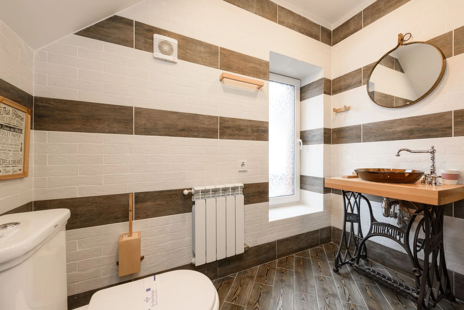 Elegant bathroom featuring a rustic wood vanity and modern fixtures in natural light