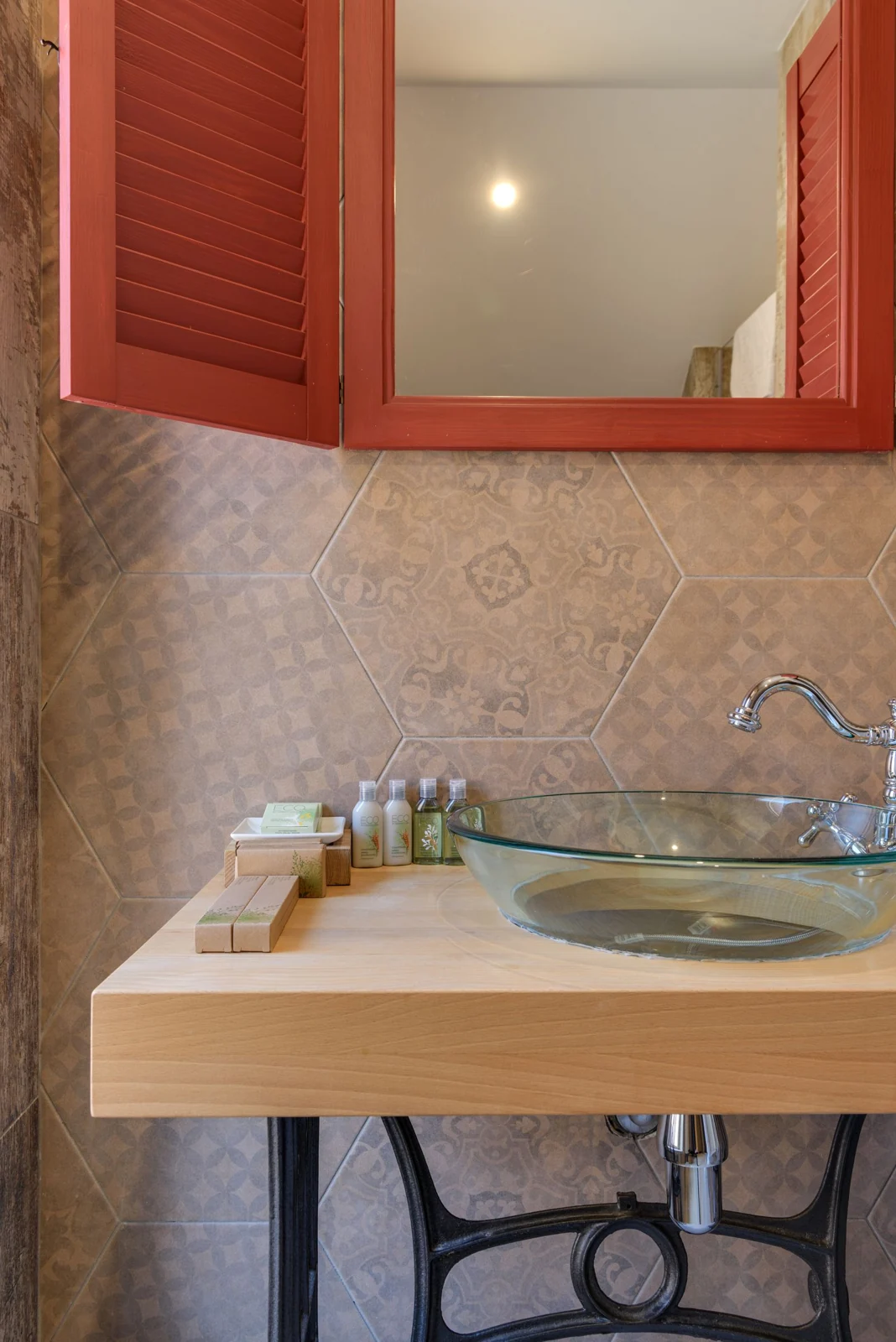 Bathroom basin and red-framed mirror