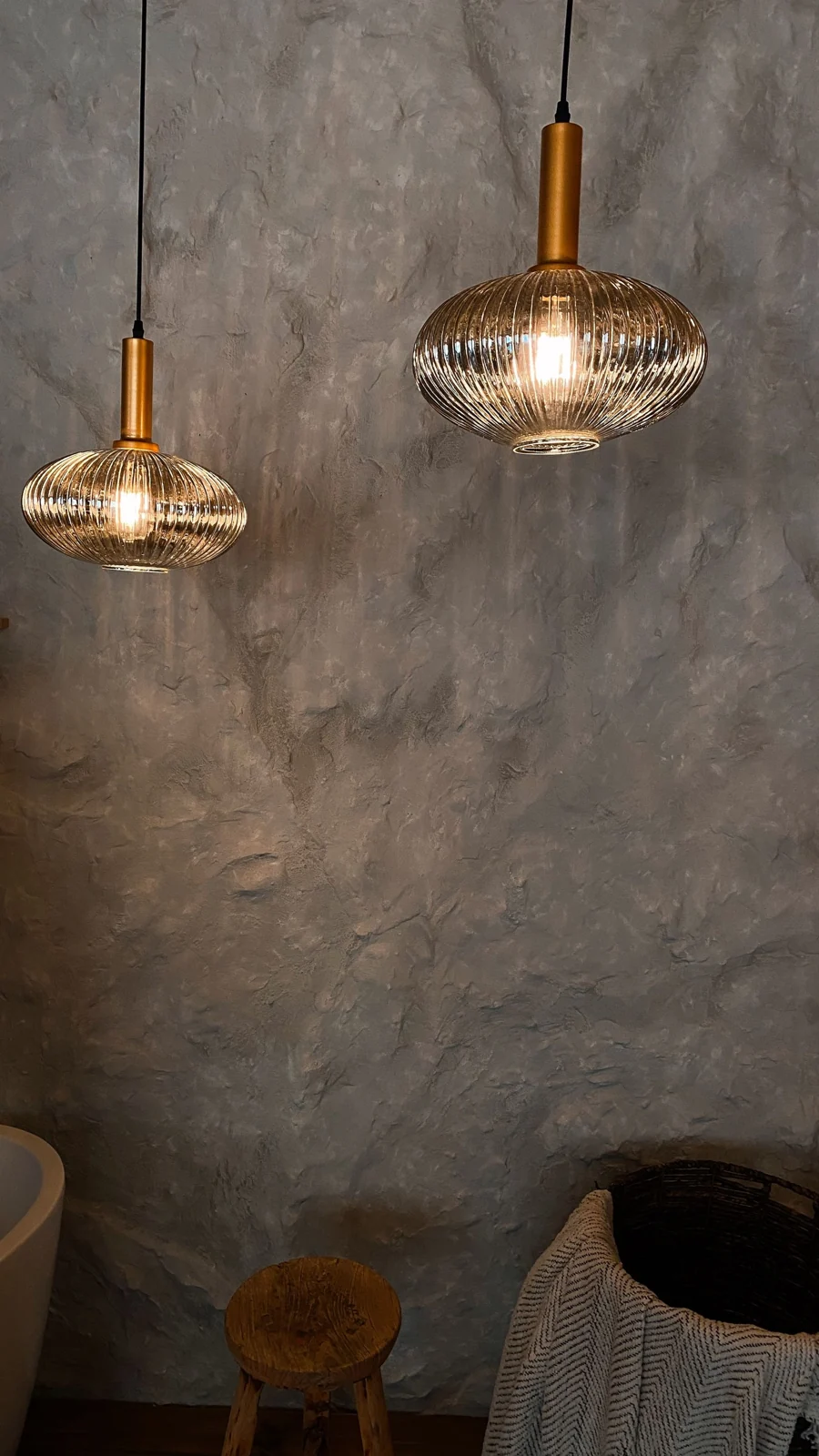 Brass shower heads against tiled walls