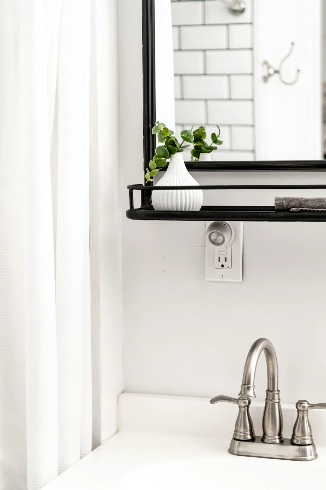 Bathroom basin below a wall mirror