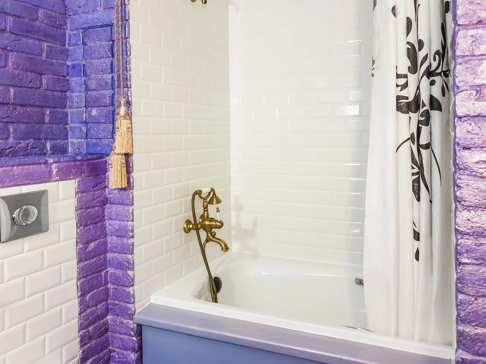 Vibrant bathroom with purple brick wall and classic white tiles for a modern look